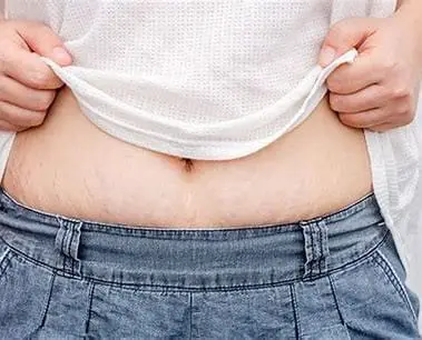 A person holding their stomach in front of his belly.